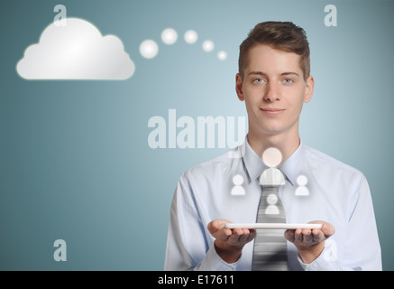 Businessman holding computer tablet with social media people icons in the cloud Stock Photo