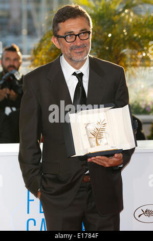 Director Nuri Bilge Ceylan poses with the Palme d'Or for his film 'Winter's Sleeps' during the photocall with the awards winner at the 67th Cannes Film Festival on May 24, 2014 Stock Photo