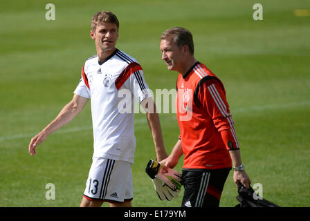 Passeier, Italy. 25th May, 2014. Thomas Mueller (L) and goalkeeper coach Andreas Koepke of the German national soccer arrive for warm-up prior to a friendly match against the German U20 team on a training ground at St. Leonhard in Passeier, Italy, 25 May 2014. Germany's national soccer squad prepares for the upcoming FIFA World Cup 2014 in Brazil at a training camp in South Tyrol until 30 May 2014. Photo: Andreas Gebert/dpa/Alamy Live News Stock Photo