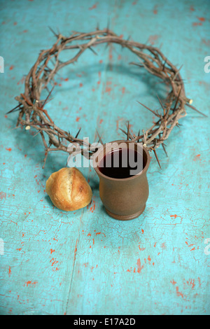 Bread, cup of wine and crown of thorns over vintage table Stock Photo