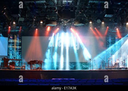 Stage lights with cross and communion trays in foreground Stock Photo