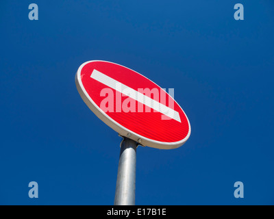 No entry road sign against a clear blue sky Stock Photo