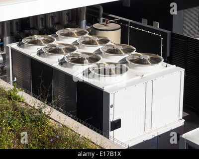 Large industrial air conditioning units on a building rooftop Stock Photo