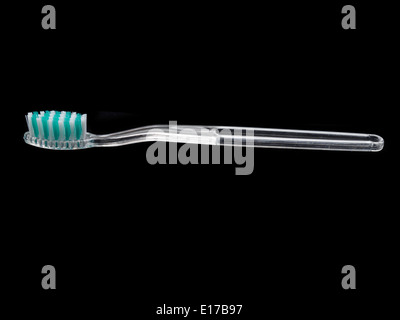 Transparent plastic toothbrush isolated on black background Stock Photo