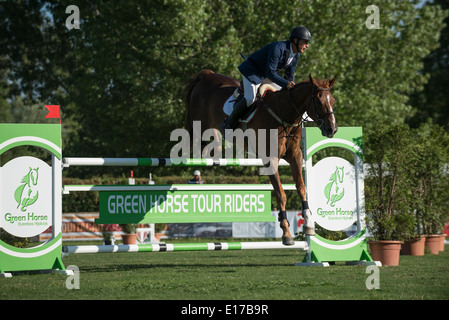 A rider and horse jump over an obstacle during the Longines Global ...