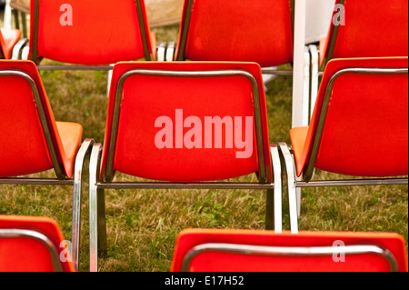 Chairs lined up in rows close-up of backs of the red chairs Stock Photo