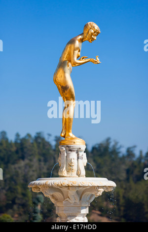 Hearst Castle California. Gold sculpture of a Princess holding a Crowned Frog Prince in her hand, about to kiss him. Stock Photo