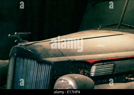 A dusty old Packard sits in a garage. Stock Photo