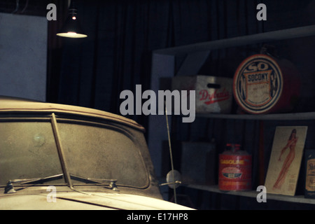 A dusty old Packard sits in a garage. Stock Photo