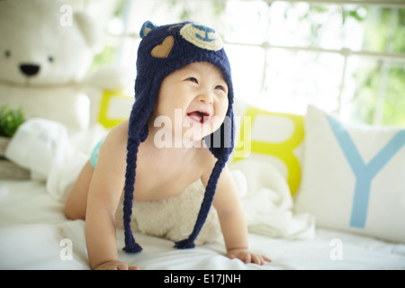 Cute baby wearing a blue bear hat Stock Photo