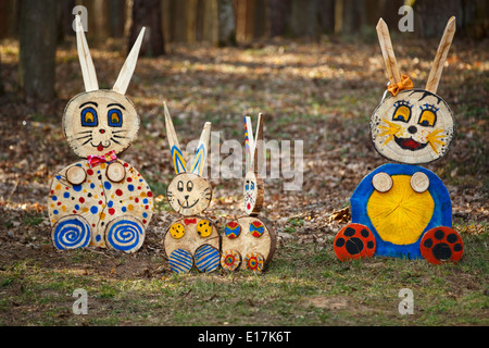 Colorful rabbit family figures in the forest Stock Photo