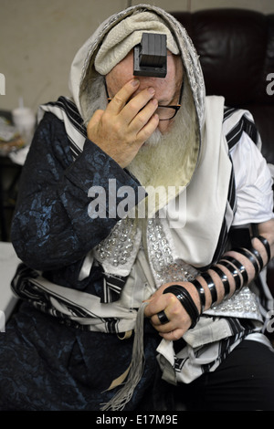 Rabbi praying in his house during the week he was mourning the loss of ...