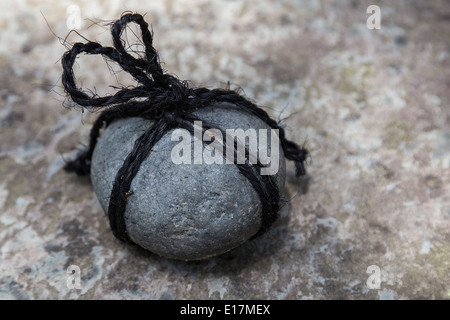 Tome Ishi is a stone is wrapped in rope and placed in a path or in front of a gate. It means 'do not enter'. Stock Photo