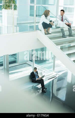 Doctor and administrator talking on hospital stairs Stock Photo