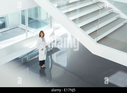 Portrait of confident doctor in hospital lobby Stock Photo