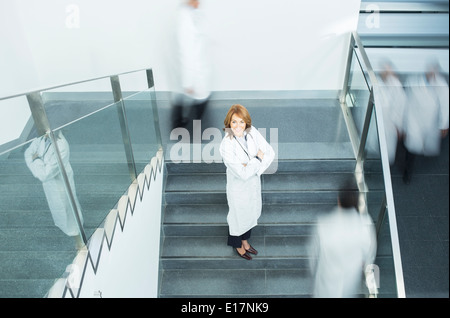 Portrait of confident doctor on staircase Stock Photo