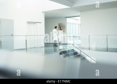 Doctors talking in hospital corridor Stock Photo