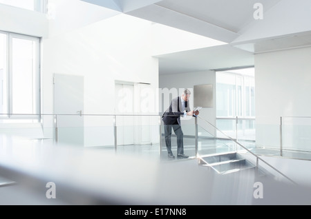 Businessman using digital tablet in corridor Stock Photo