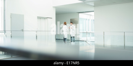 Doctors talking in hospital corridor Stock Photo