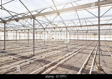 Irrigation pipes in empty greenhouse Stock Photo