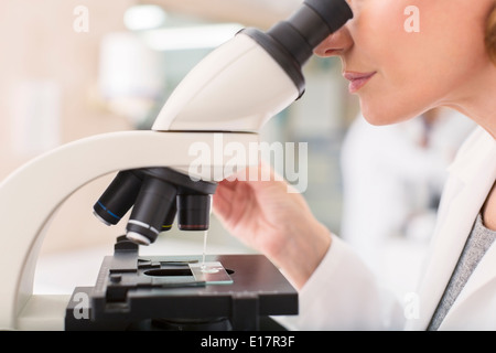 Scientist using microscope in laboratory Stock Photo