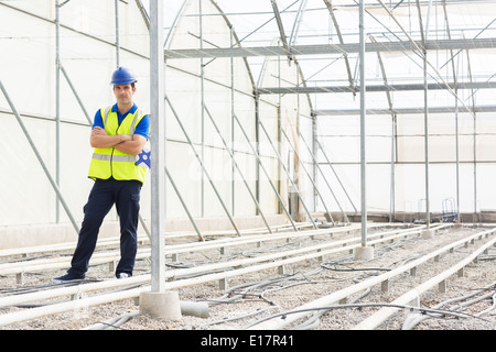 Portrait of confident engineer in greenhouse Stock Photo