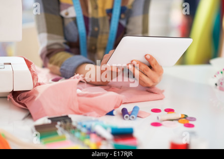 Closeup on seamstress using tablet pc at work Stock Photo