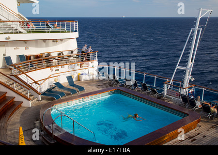 Woman swimming in aft pool of the Emerald of the Seas Cruise Ship, Princess Cruise Line Stock Photo