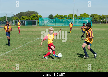 Junior football player dodges a defender, Cape Town, South Africa Stock Photo