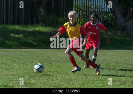 Junior football players running with the ball, Cape Town, South Africa Stock Photo