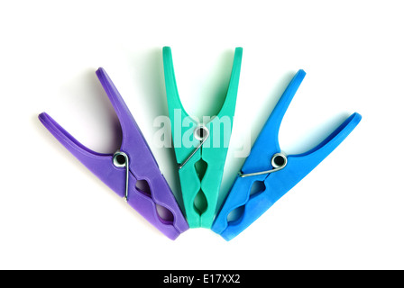 Three plastic clothes pegs on a white background Stock Photo