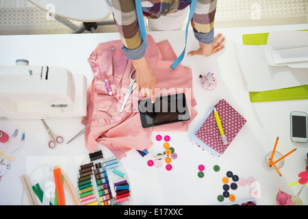 Closeup on seamstress using tablet pc at work Stock Photo