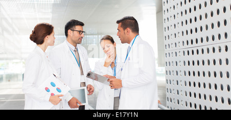 Doctors talking in hospital corridor Stock Photo