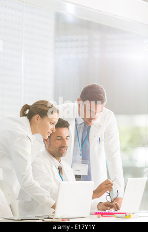 Doctors using laptop in hospital Stock Photo