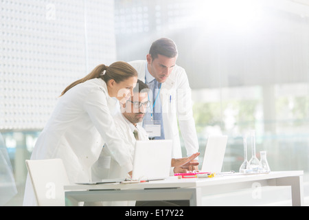 Doctors using laptop in laboratory Stock Photo