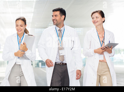 Doctors walking in hospital corridor Stock Photo