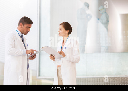 Doctors with digital tablet and clipboard in hospital Stock Photo
