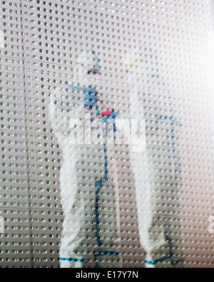 Scientists in clean suits working in laboratory Stock Photo