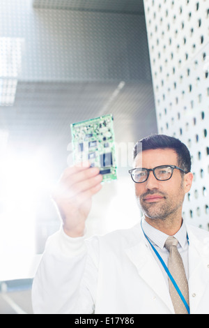 Engineer examining circuit board Stock Photo