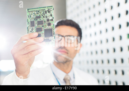 Engineer examining circuit board Stock Photo