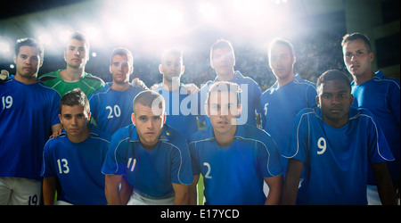 Soccer team standing in stadium Stock Photo