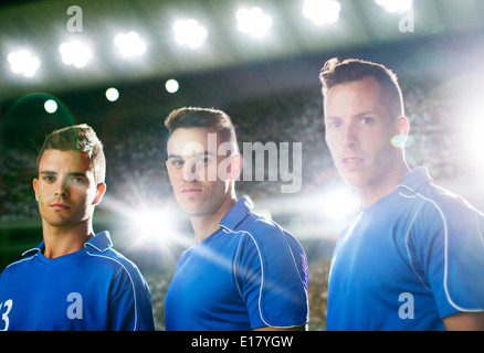 Soccer players standing on field Stock Photo