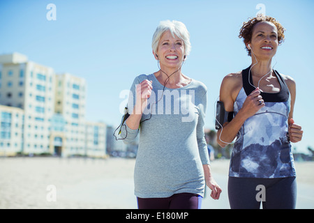 Senior women jogging outdoors Stock Photo