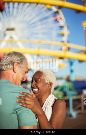 Enthusiastic senior couple at amusement park Stock Photo