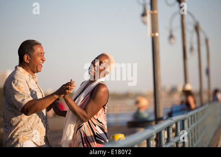 Senior couple dancing on pier Stock Photo