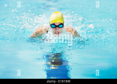 Swimmer wearing goggles in pool Stock Photo