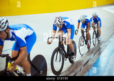 Track cycling team riding in velodrome Stock Photo