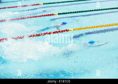 Swimmers racing in pool Stock Photo