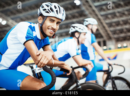 Track cycling team waiting in velodrome Stock Photo