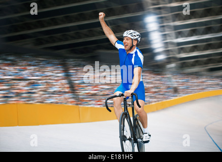 Track cyclist celebrating in velodrome Stock Photo